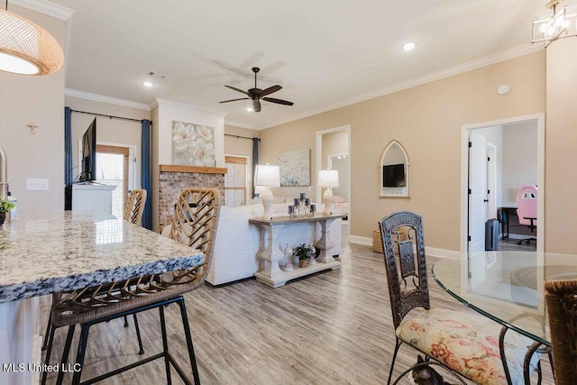 interior space with hardwood / wood-style flooring, ceiling fan, and ornamental molding