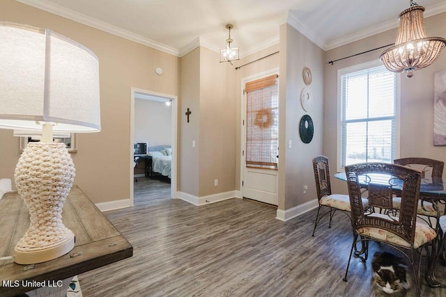 dining space with a notable chandelier, ornamental molding, and dark wood-type flooring