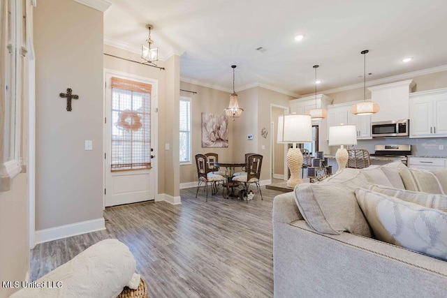 living room featuring wood-type flooring and ornamental molding