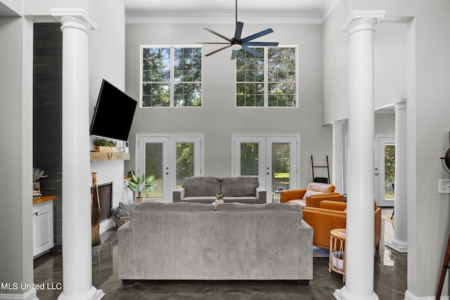 living room featuring french doors, ornamental molding, ceiling fan, and a wealth of natural light