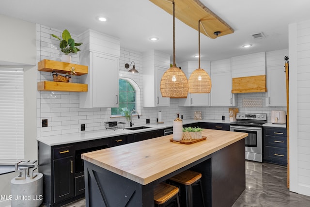 kitchen featuring white cabinetry, a center island, hanging light fixtures, and stainless steel electric range oven