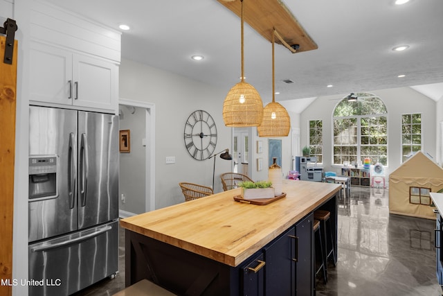 kitchen featuring a kitchen island, wood counters, pendant lighting, white cabinets, and stainless steel refrigerator with ice dispenser