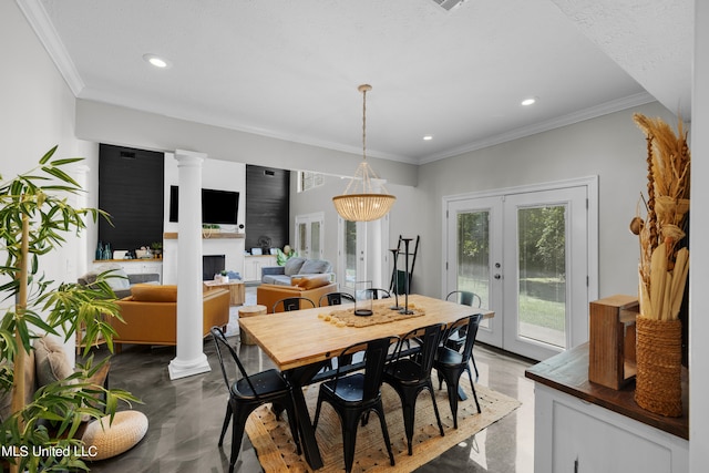 dining area featuring french doors, concrete floors, a notable chandelier, and ornamental molding