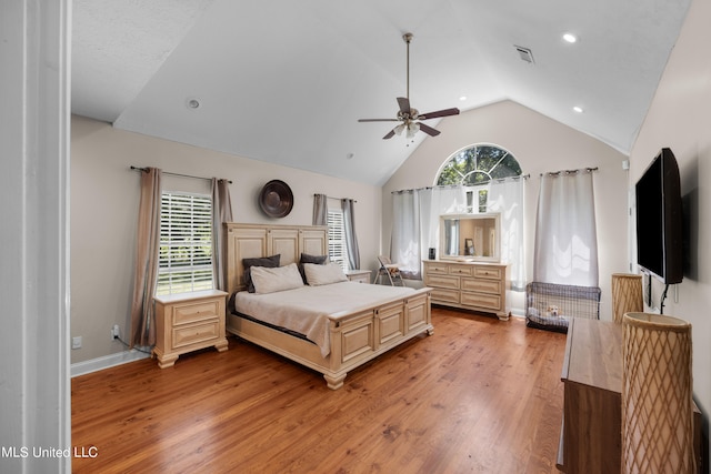 bedroom featuring light hardwood / wood-style floors, lofted ceiling, and ceiling fan