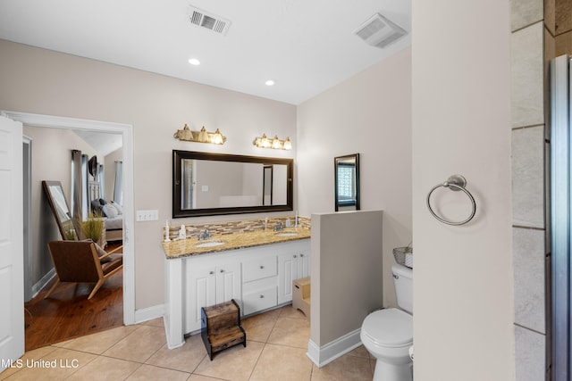 bathroom featuring vanity, toilet, and tile patterned flooring