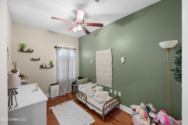 bedroom featuring hardwood / wood-style floors and ceiling fan