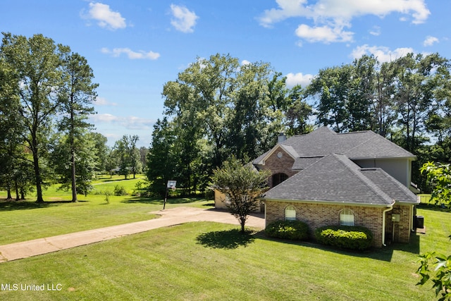 view of side of property with a yard