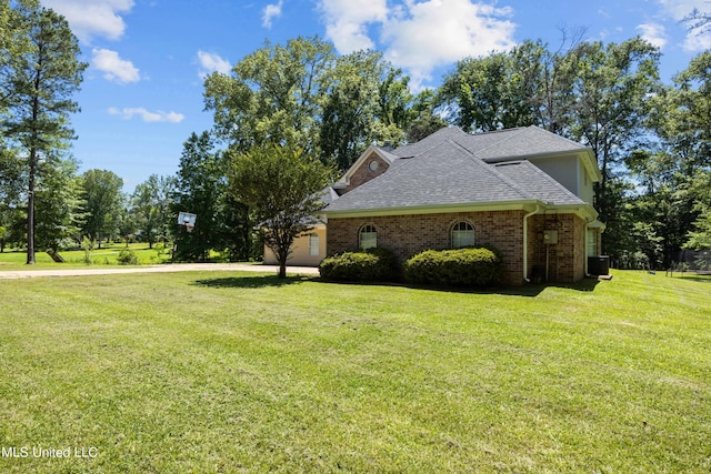 view of home's exterior featuring a lawn and a garage