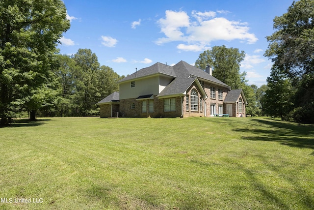 view of side of home with a yard