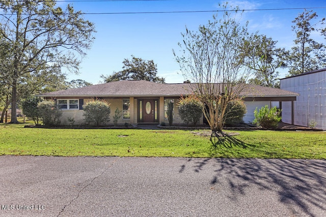 single story home featuring a garage and a front lawn