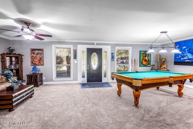 rec room with carpet, a wealth of natural light, crown molding, and ceiling fan