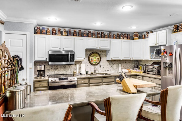 kitchen featuring stainless steel appliances, white cabinetry, ornamental molding, and sink