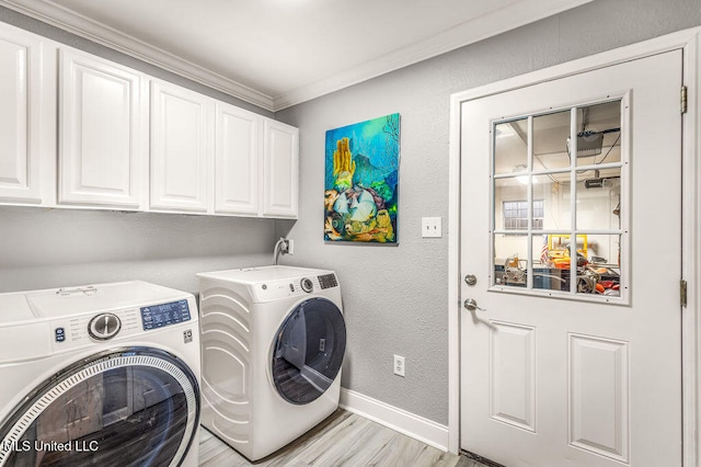 washroom with cabinets, light hardwood / wood-style flooring, washer and clothes dryer, and ornamental molding