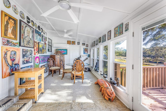 sunroom featuring ceiling fan and vaulted ceiling