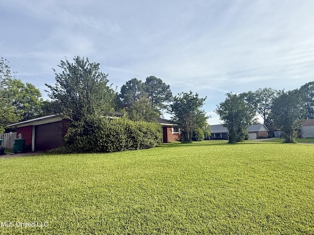 15449 Mimosa Dr, Gulfport, MS 39503 - view of green lawn with an attached garage