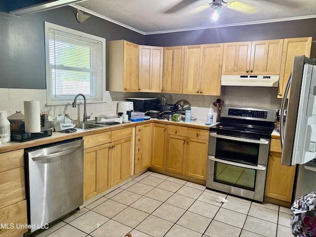 15449 Mimosa Dr, Gulfport, MS 39503 - kitchen with appliances with stainless steel finishes, under cabinet range hood, tile counters, tasteful backsplash, and light brown cabinetry