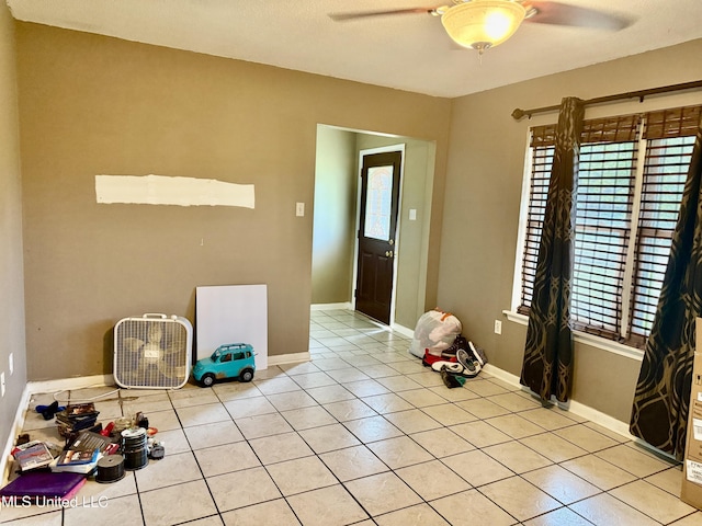 15449 Mimosa Dr, Gulfport, MS 39503 - unfurnished dining area featuring a ceiling fan, light tile patterned floors, and baseboards