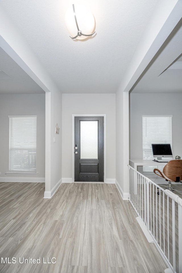 entrance foyer with wood finished floors and baseboards