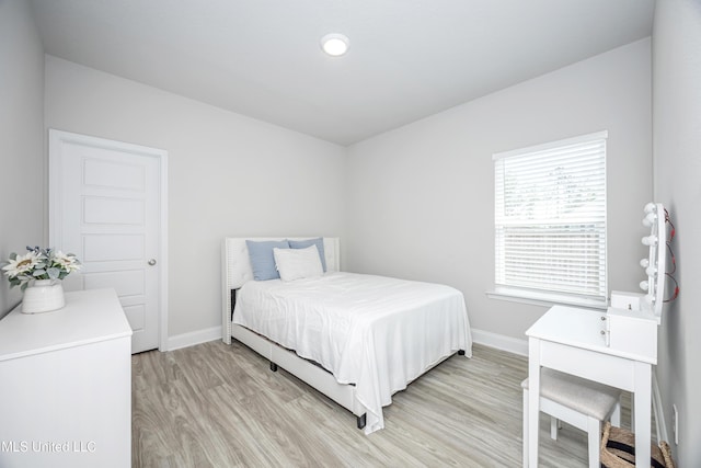 bedroom with baseboards and light wood-style floors