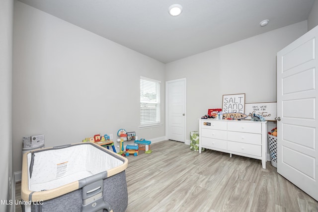 rec room featuring wood finished floors and baseboards