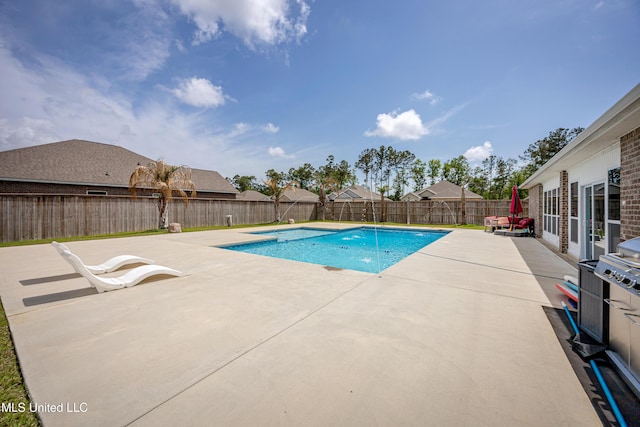 view of swimming pool with a fenced backyard, a fenced in pool, and a patio area