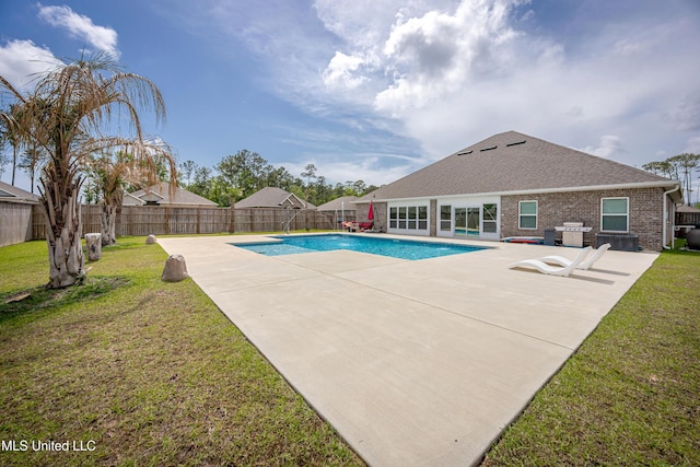 view of pool featuring a patio, a fenced in pool, and a yard