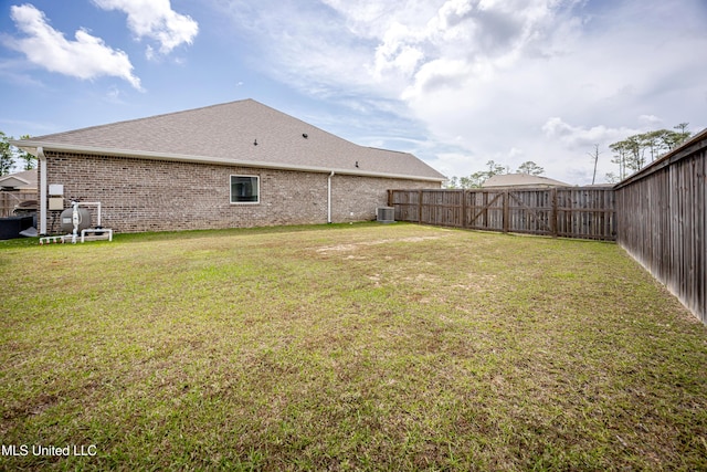 view of yard with central AC and a fenced backyard