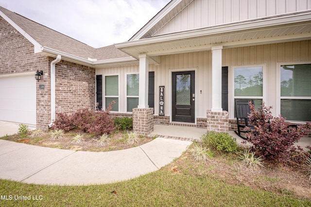entrance to property featuring brick siding, a porch, a shingled roof, and an attached garage