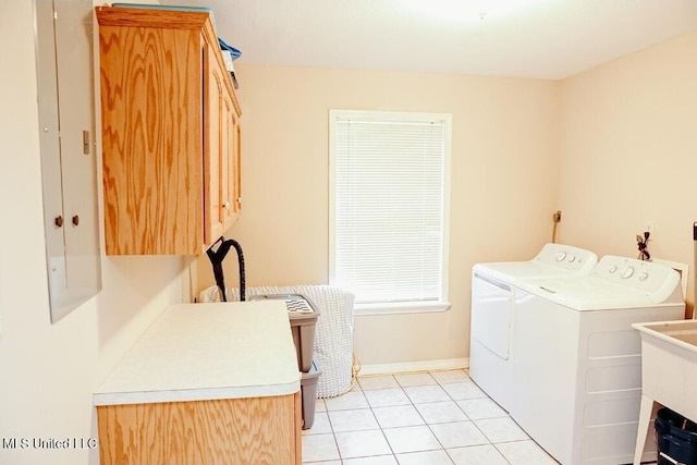 2208 Highland Dr, Gautier, MS 39553 - laundry room with cabinet space, washer and dryer, light tile patterned flooring, electric panel, and baseboards