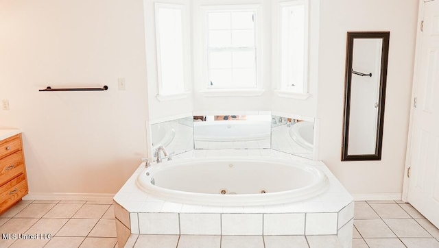 2208 Highland Dr, Gautier, MS 39553 - full bath with a tub with jets, vanity, baseboards, and tile patterned flooring