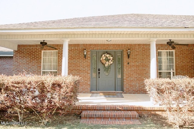 2208 Highland Dr, Gautier, MS 39553 - view of exterior entry featuring ceiling fan, a porch, brick siding, and roof with shingles