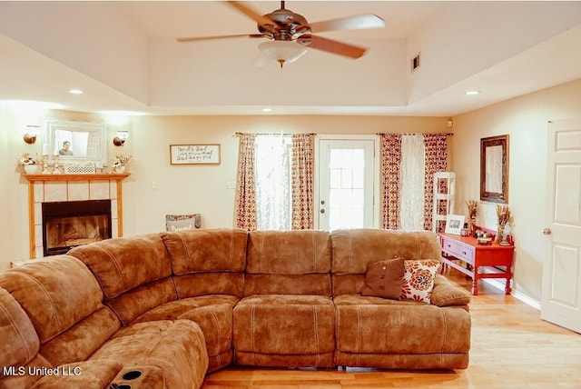 2208 Highland Dr, Gautier, MS 39553 - living room with light wood-type flooring, a ceiling fan, a tiled fireplace, recessed lighting, and baseboards