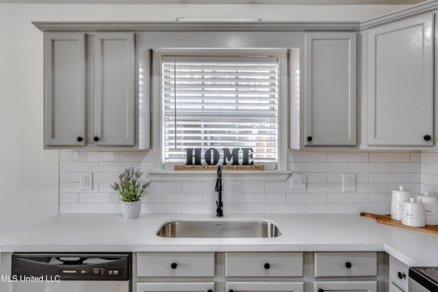 kitchen featuring dishwasher, stove, a sink, and decorative backsplash