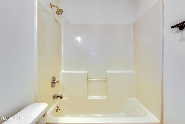 bathroom with shower / bathing tub combination and toilet