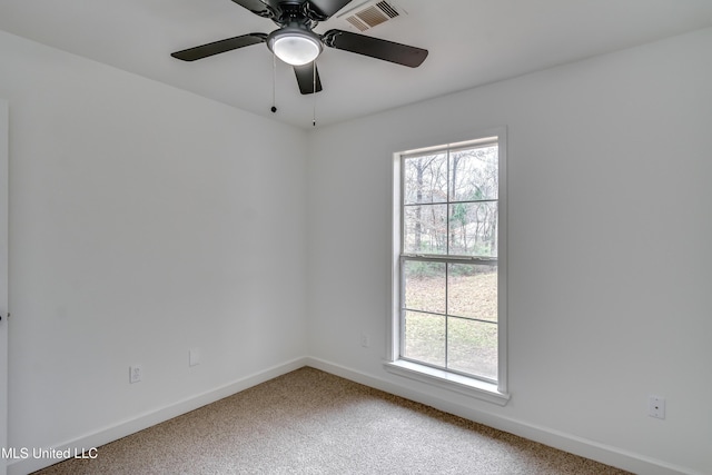 empty room featuring baseboards, visible vents, and a wealth of natural light