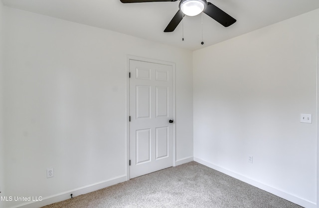 spare room with a ceiling fan, baseboards, and carpet flooring