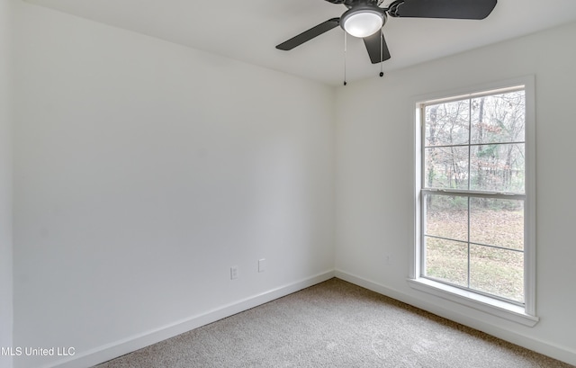 carpeted empty room featuring a ceiling fan, a healthy amount of sunlight, and baseboards