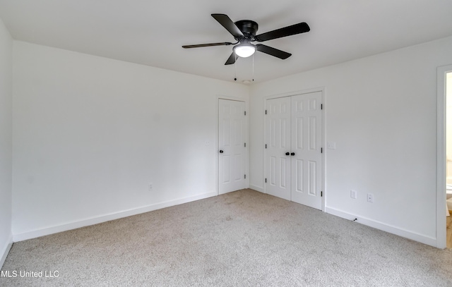 spare room featuring ceiling fan, baseboards, and carpet flooring