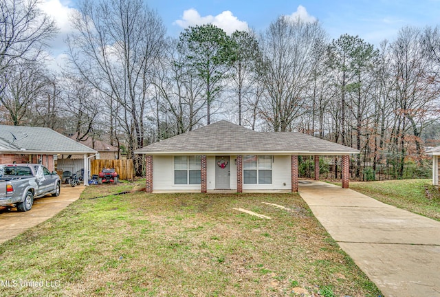 ranch-style home with driveway, a front lawn, a carport, and brick siding