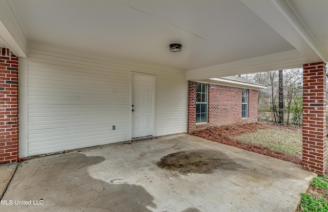 view of patio featuring driveway and a carport