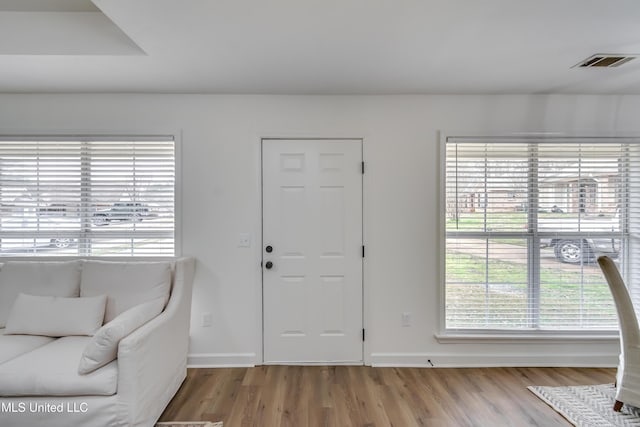 entryway featuring light wood-type flooring, visible vents, and baseboards