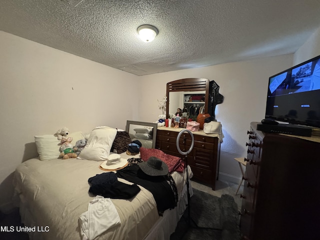 2730 E Angela Cir, Gulfport, MS 39503 - bedroom with carpet, a textured ceiling, and arched walkways