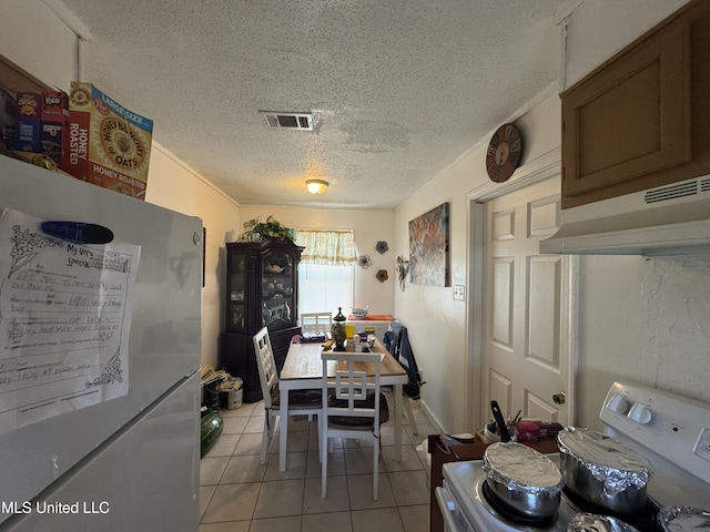 2730 E Angela Cir, Gulfport, MS 39503 - dining area with light tile patterned floors and a textured ceiling