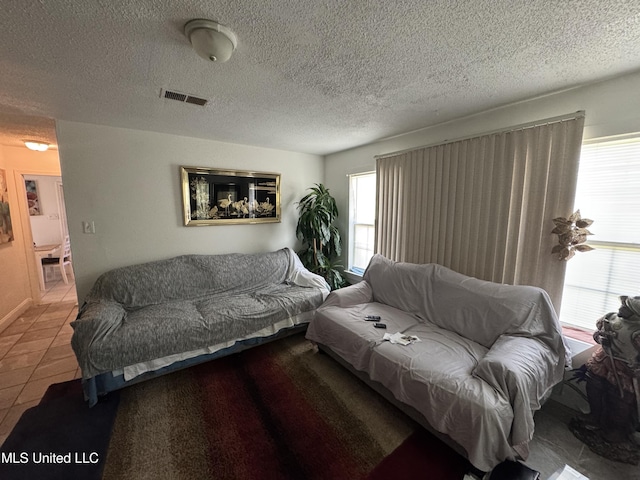 2730 E Angela Cir, Gulfport, MS 39503 - tiled living room with a textured ceiling