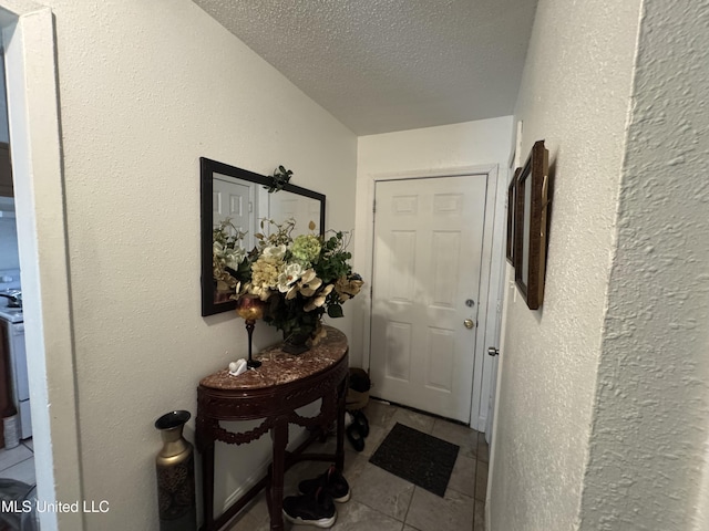 2730 E Angela Cir, Gulfport, MS 39503 - entryway featuring a textured ceiling and tile patterned flooring
