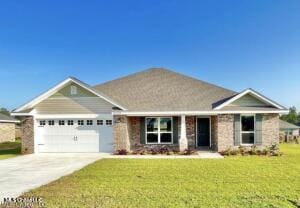 view of front of property with a front yard and a garage