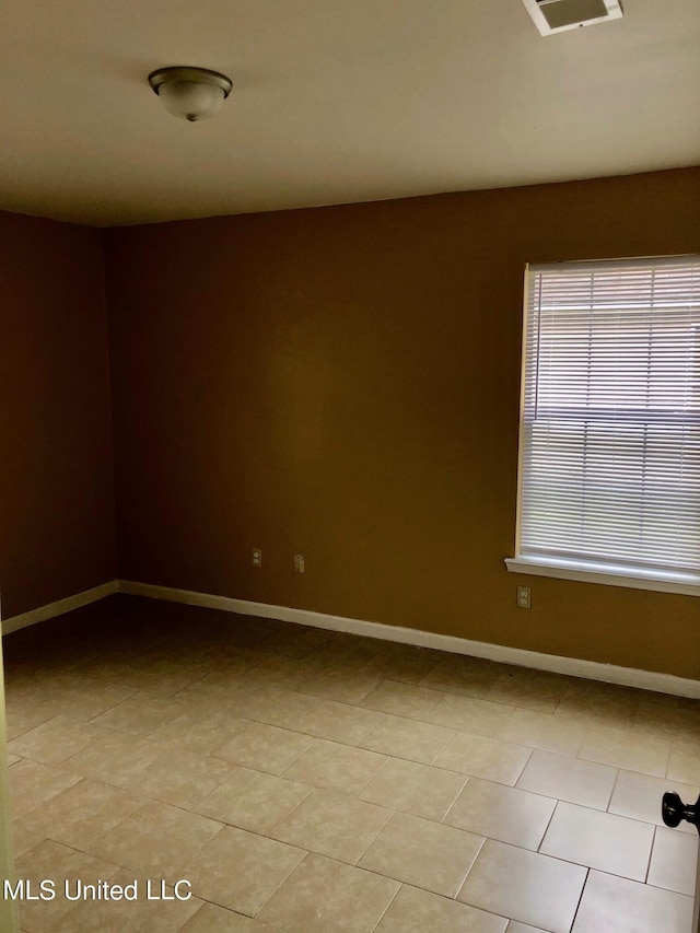 unfurnished room with light tile patterned floors