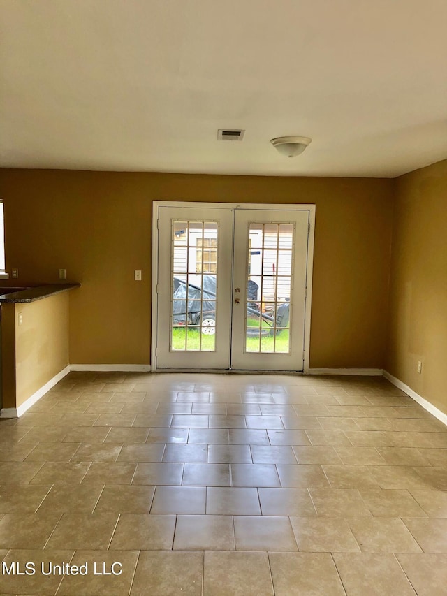 doorway to outside featuring french doors and light tile patterned floors