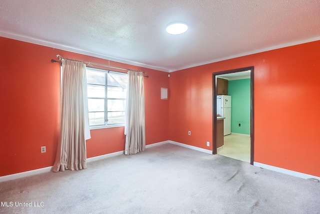 carpeted empty room featuring a textured ceiling