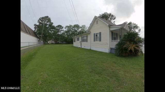 view of side of home featuring a lawn